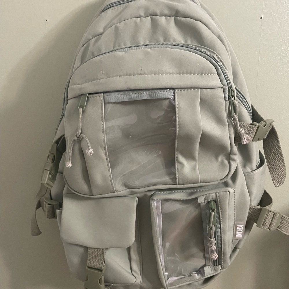 Green backpack with many pockets